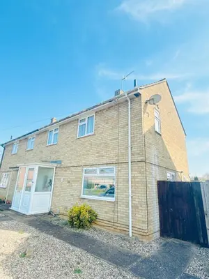 a brick house with a white door at Heartfelt Cambridge Home in Cottenham