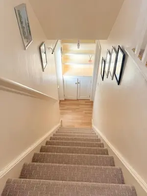 a staircase in a house with a stair case at Heartfelt Cambridge Home in Cottenham