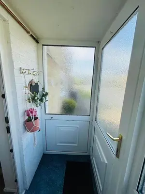 a door with a window and a potted plant at Heartfelt Cambridge Home in Cottenham
