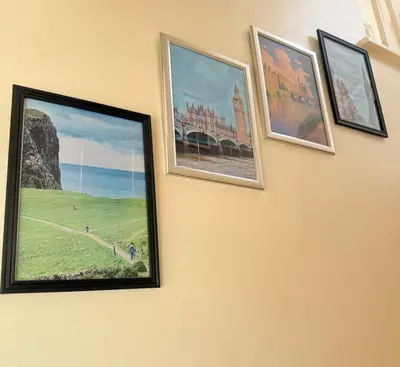 a group of pictures hanging on a wall at Heartfelt Cambridge Home in Cottenham