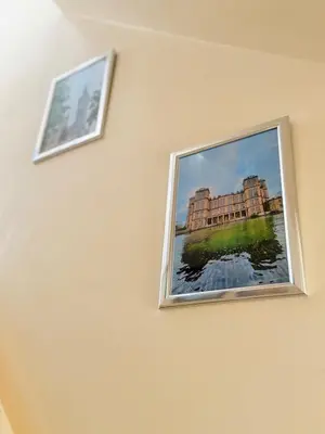 two pictures of a building on a wall at Heartfelt Cambridge Home in Cottenham