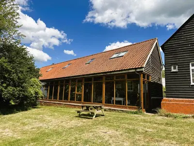 a building with a bench in front of it at Thaxted Bed & Breakfast and Accommodation in Thaxted