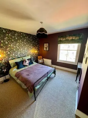 a bedroom with a bed and a window in it at Quaint Bury St Edmunds Cottage in Bury Saint Edmunds