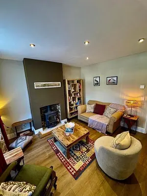 a living room with a couch and a fireplace at Quaint Bury St Edmunds Cottage in Bury Saint Edmunds