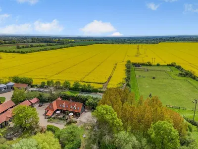 an aerial view of a farm with a house and a field at Chestnut Tree Barn in Saint Lawrence