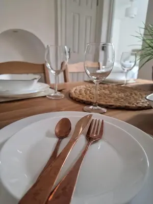 a white plate with a fork and knife on a table at Stansted Stop Over in Takeley