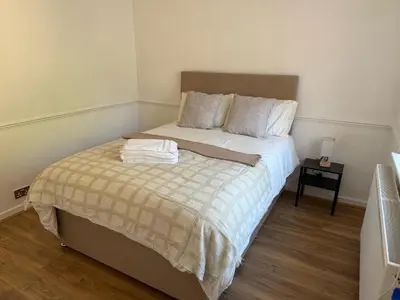 a bedroom with a bed with a towel on it at Stansted Stop Over in Takeley
