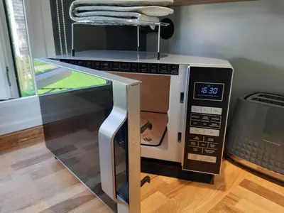 a microwave oven with its door open on a table at All Manor Of Events - Glamping Pods in Henley