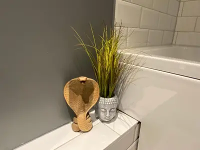 a plant in a pot next to a toilet in a bathroom at Sanctuary Rooms in Brightlingsea