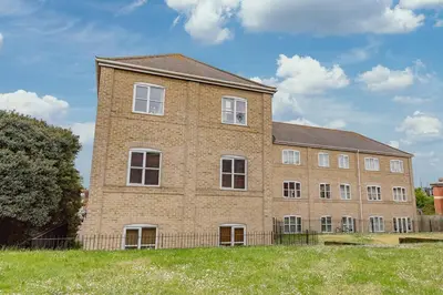 a large brick building in the middle of a field at Spacious 3 bed flat in Colchester - Free parking in Hythe