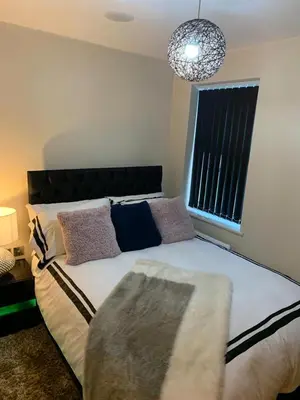 a bedroom with a large bed and a window at Two Bed Flat By The Beach No Parties No Events in Southend-on-Sea