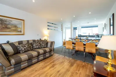 a living room with a couch and a table at 7 The Plantation - Aldeburgh Coastal Cottages in Aldeburgh