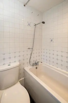 a white bathroom with a toilet and a tub at 7 Coastguards Cottages - Aldeburgh Coastal Cottages in Aldeburgh