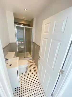 a bathroom with a white door and a toilet at The Essex Atelier Studio Flat 2 in Chelmsford