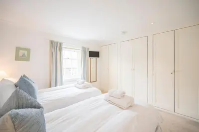 a bedroom with two beds with towels on them at 207 High Street, Aldeburgh in Aldeburgh