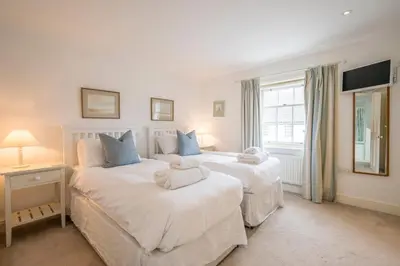 two beds in a room with two white beds at 207 High Street, Aldeburgh in Aldeburgh