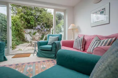 a living room with a couch and two chairs at 207 High Street, Aldeburgh in Aldeburgh