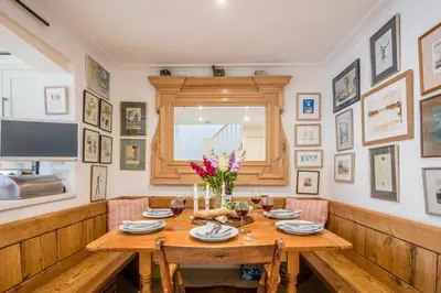 a dining room with a wooden table and chairs at 207 High Street, Aldeburgh in Aldeburgh