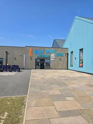 a building with a sign on the side of it at FI005 Loomy Escapes Caravan at St Osyth Beach Essex in Saint Osyth