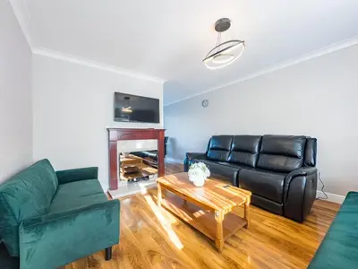 a living room with a couch and a table at Urban Ease Basildon in Basildon