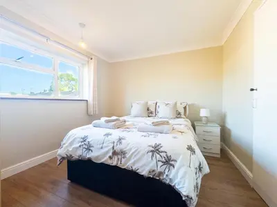 a bedroom with a bed and a window at Urban Ease Basildon in Basildon
