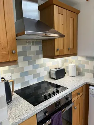 a kitchen with a stove top oven in a kitchen at Elm Barn in Diss