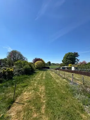 a dirt road in a field with a fence at 5 chapel lane Wymondham Norfolk in Wymondham