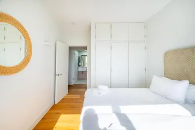 a bedroom with two beds and a mirror at Heath House 4 in Thorpeness