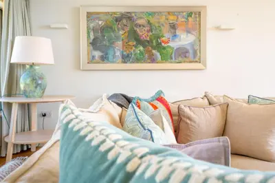 a living room with a couch with pillows on it at Heath House 4 in Thorpeness