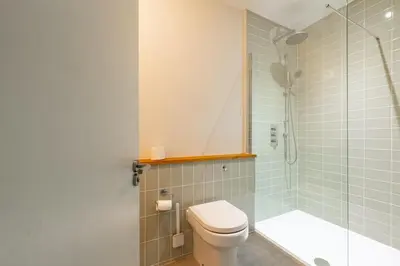 a bathroom with a toilet and a shower at Heath House in Thorpeness