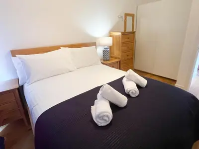 a bedroom with a bed with two towels on it at Modern stylish house in Charming Fen Ditton Village in CBG
