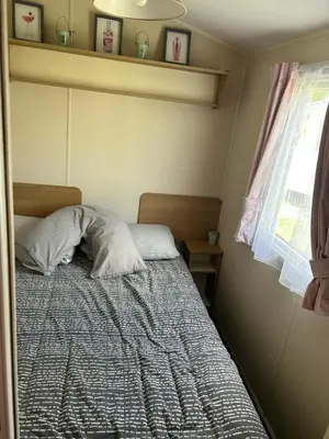 a bedroom with a bed and a window at Perfect days away - 3 bedroom 1 shower with decking & bedding in Colchester