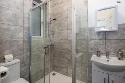 a bathroom with a shower and a toilet and a sink at 1 Bed Apartments, 2 Mins to Beach, Sleeps 4 in Southend-on-Sea