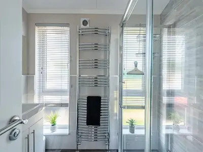 a shower stall in a bathroom with two potted plants at Sunnyfields in Cambridge