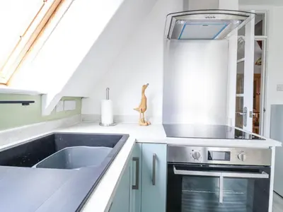 a kitchen with a sink and a stove at Kingfisher in Ely