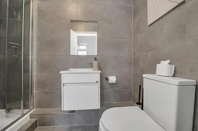 a bathroom with a toilet and a sink and a shower at Weekly Deal- 4BDR House By Homestyles Hosts Short Lets & Serviced Accommodation Suffolk With Private En-Suite & Free Parking in Ipswich