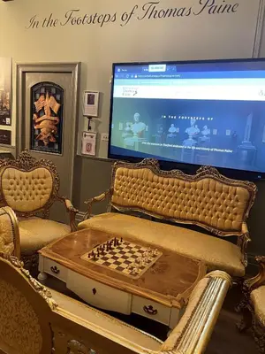 a living room with a chess board and a television at Thomas Paine Hotel in Thetford