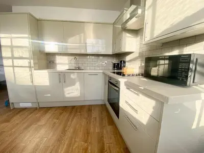 a kitchen with white cabinets and a counter top at Essex Studio Retreat Flat 4 in Chelmsford
