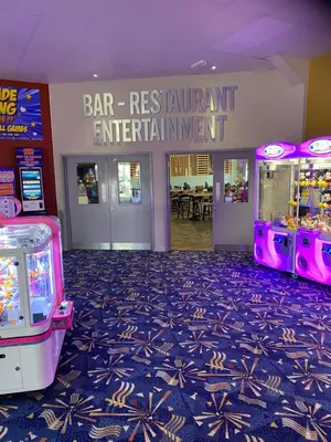 a bar restaurant entertainment center with two video games at Hadleigh Caravans at Seawick Clacton in Clacton-on-Sea