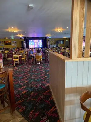 a restaurant with people sitting at tables and a bar at Hadleigh Caravans at Seawick Clacton in Clacton-on-Sea
