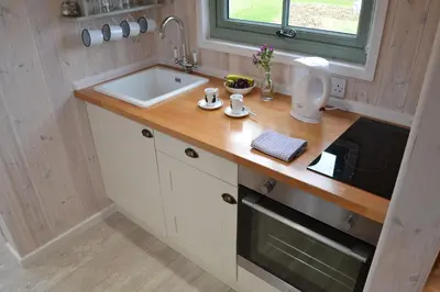 a kitchen with a sink and a counter top at Shepherds Hut 5 in Woodbridge