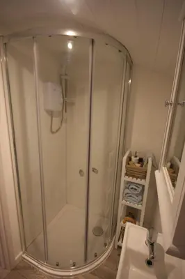 a shower stall in a bathroom with a sink at Shepherds Hut 5 in Woodbridge