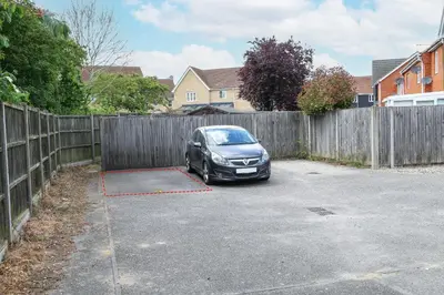 a car parked in a driveway next to a fence at Stylish 2 Bedroom Property in Bury Saint Edmunds