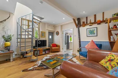 a living room with a couch and a glass table at 28 Church Ponds, Castle Hedingham in Castle Hedingham