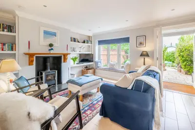 a living room filled with furniture and a fireplace at Samphire in Aldeburgh