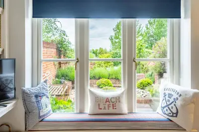 a window with two pillows sitting in front of it at Samphire in Aldeburgh