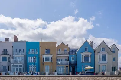 a row of colorful houses on the beach at Samphire in Aldeburgh