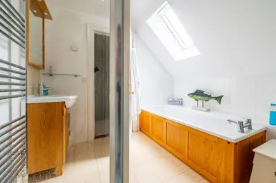 a bathroom with a sink and a bath tub at Samphire in Aldeburgh
