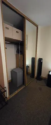 a reflection of a room with a mirror and a room with aerate at 1 bed luxurious flat in Basildon