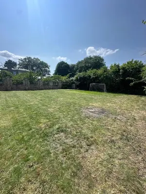 a large grass field with a soccer ball in it at The Old stables Barn in Old Hurst